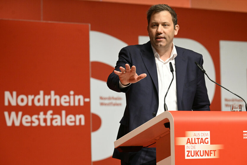 Mann gestikuliert von Rednerpult aus