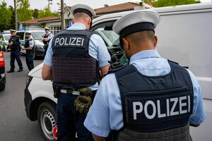 Zwei Polizisten kontrollieren an einer Grenze