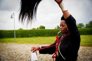 Künstlerin Tuli Mekondjo schwenkt in Nauen bei einer rituellen Performance ein Haarwedel