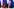 Wladimir Putin sitzt an einem Tisch. Hinter ihm sind die Farben der russischen Flagge zu sehen.