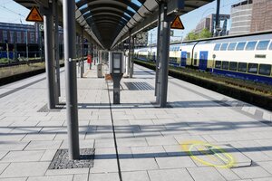 Ein Bahnsteig des Hamburger Hauptbahnhofs außerhalb der Bahnhofshalle. Auf dem Boden eine gelbe Markierung, auf dem Nachbargleis ein Regionalzug
