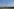 Ein Windrad steht in einer hügeligen Landschaft