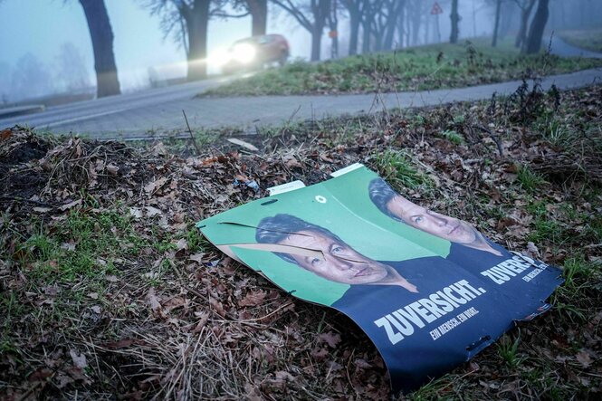 Wahlplakate mit Robert Habeck liegen am frühen Morgen neben einer Straße