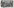 Man sieht ein Schwarz-Weiß Foto des Ensembles mit bunten grafischen Elementen.