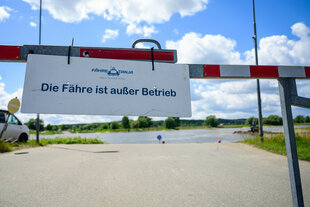 an einer Schranke hängt ein Schild 