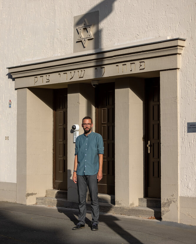 Porträt von Tom Fleischhauer vor der Synagoge in Erfurt.