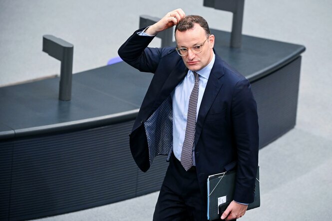Ein Mann im Anzug fasst sich mit der Hand an den Kopf im Bundestag