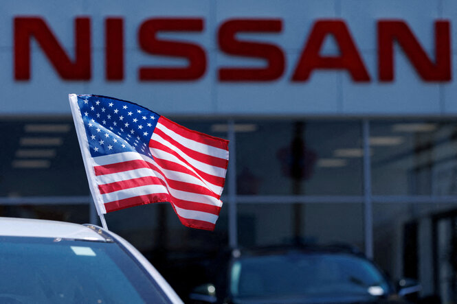Eine amerikanische Flagge ist auf einem Nissan-Fahrzeug bei einem Nissan-Händler