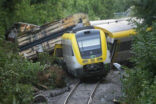Der demolierte Regionalexpress RE55 liegt neben den Schienen