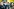 Mehrere Männer in schwarz halten Flaggen der identitären Bewegung. Rechts davon ein Fotograf mit Seitnscheitel im Profil
