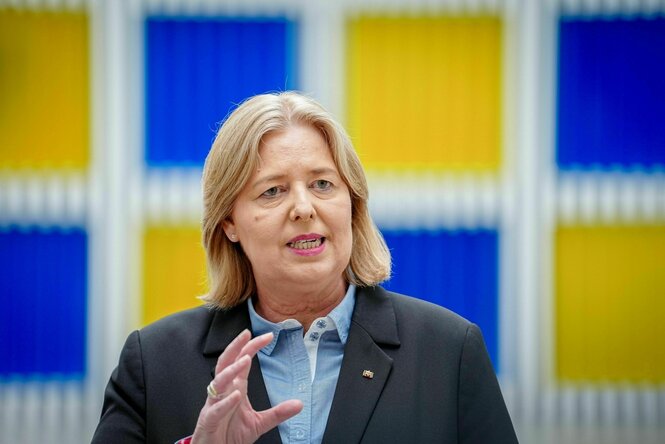 Eine Frau spricht mit Vertretern der Presse