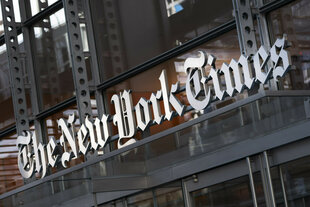 Ein Schild der New York Times hängt über dem Eingang eines Gebäudes