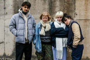 Vier junge Menschen in Winderkleidung