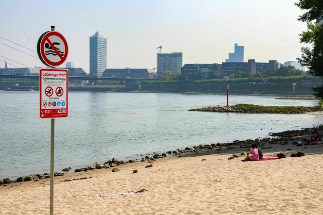 Ein Schild weißt auf das Badeverbot in Düsseldorf am Rhein hin