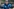Ein Mann in blauer Sportjacke und mit Schiebermütze spricht und gestikuliert dabei mit seinen Händen