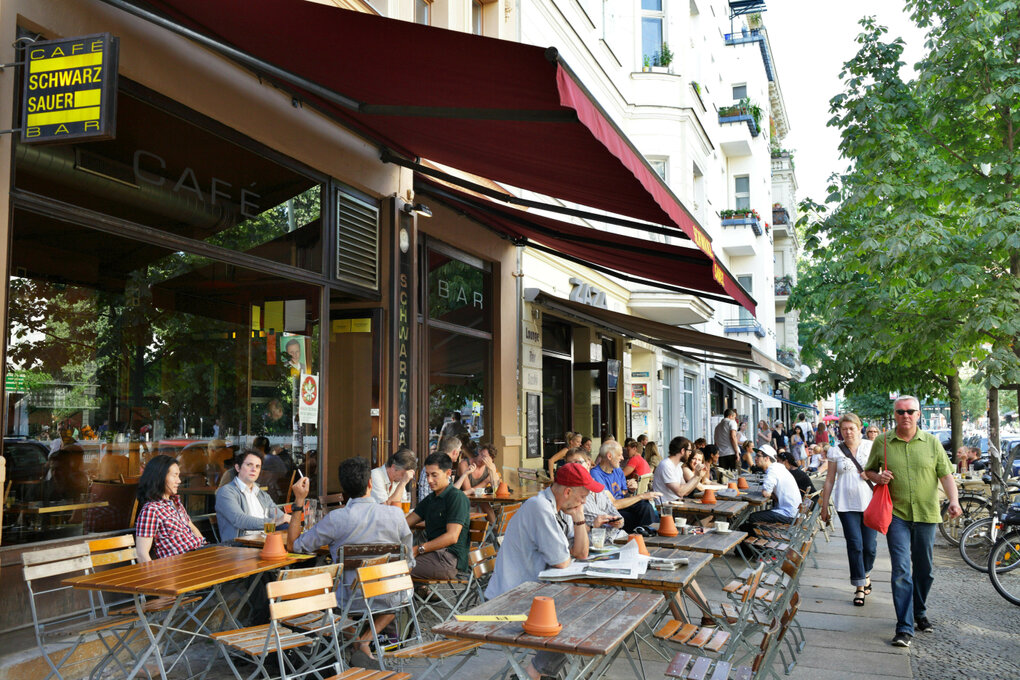 Menschen sitzen vor einem Café