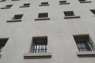 Die Fassade eines Gefängnisses mit vielen vergittertene Fenstern