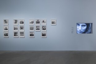 Eine Museumswand mit Fotos von Chris Marker, rechts ein Videobildschirm.