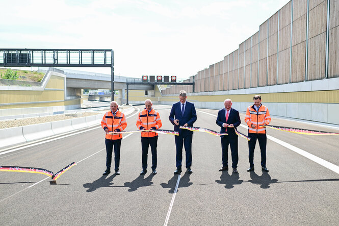 Ronald Normann (l-r), Niederlassungsdirektor der Autobahn GmbH, Dirk Brandenburger, Technischer Geschäftsführer der Autobahn GmbH des Bundes, Patrick Schnieder (CDU), Bundesminister für Verkehr, Kai Wegner (CDU), Regierender Bürgermeister von Berlin, und Michael Güntner, Vorsitzender der Geschäftsführung der Autobahn GmbH des Bundes, schneiden während eines Bildtermins zur offiziellen Freigabe an der Auf- und Ausfahrt Am Treptower Park der A100 ein Band durch.
