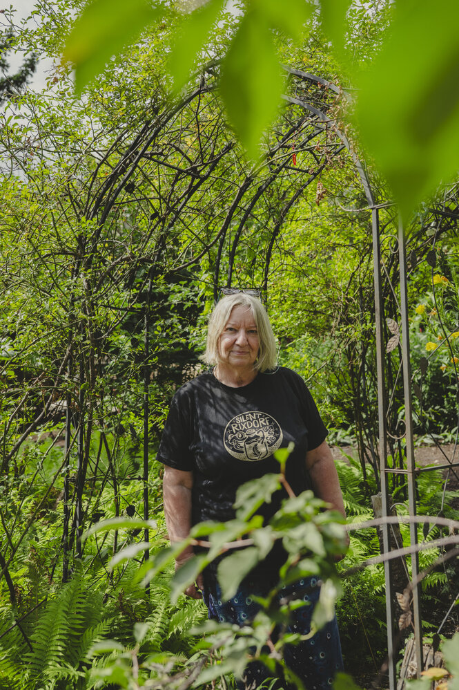Frau steht in ihrem Garten