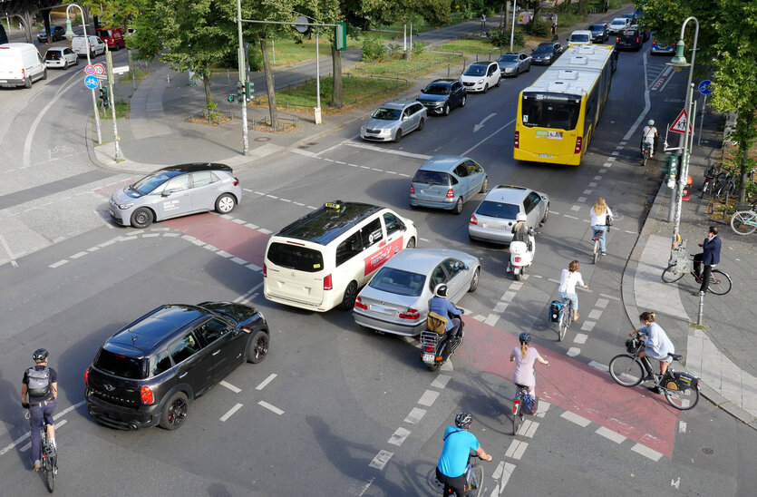 Autos und Fahrradfahrende auf einer Straßenkreuzung
