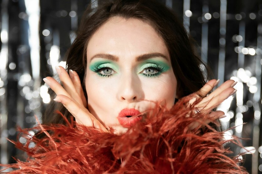 Sophie Ellis-Bextor pustet durch ihre bronzefarbene Federboa