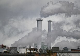 Dämpfe und Abgase quellen aus den Schornsteinen einer Papierfabrik