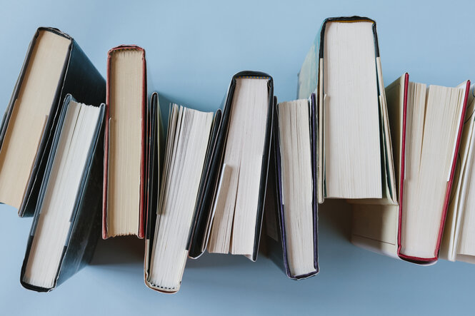 Mehrer Bücher vor blauem Hintergrund.