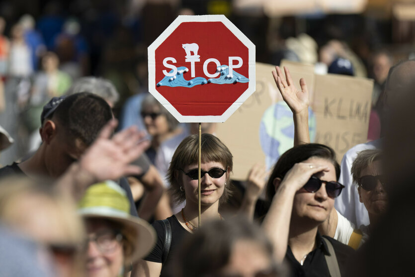 „Stop“ steht auf dem Plakat einer Frau