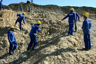 Männer in blauen Anzügen auf einer Baustelle
