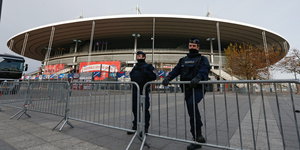 Polizisten hinter einer Absperrung am Stade de France
