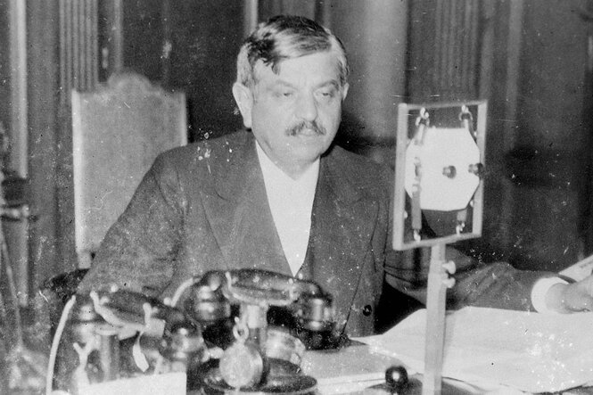 Pierre Naval sitzt vor einem Mikrofon