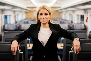 Eine Frau in einem Großraumabteil in einem Zug