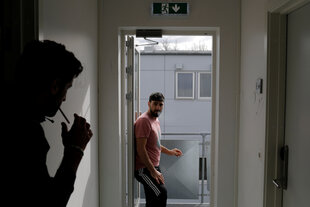 Zwei Männer stehen an einer geöffneten Tür