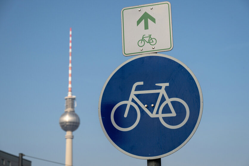 Ein Strassenschild mit Fahrrad, dahinter der Fernsehturm