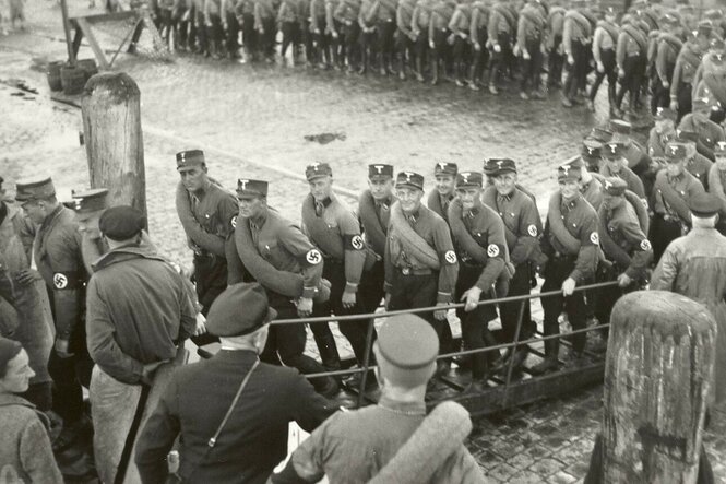 Eine lange Schlage von SA-Wachleuten besteigt ein Boot