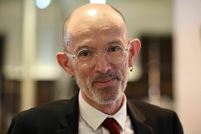 Ein Mann mit Brille lächelt in die Kamera