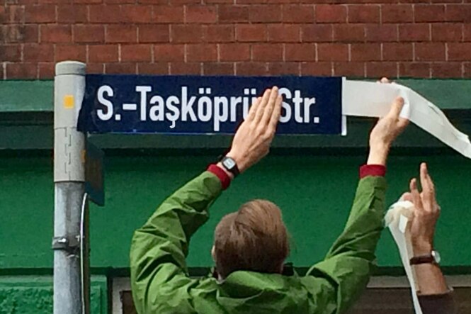 Ein Straßenschild in der Kieler Kaiserstraße wird überklebt mit "S.-Tasköpru-Str." überklebt