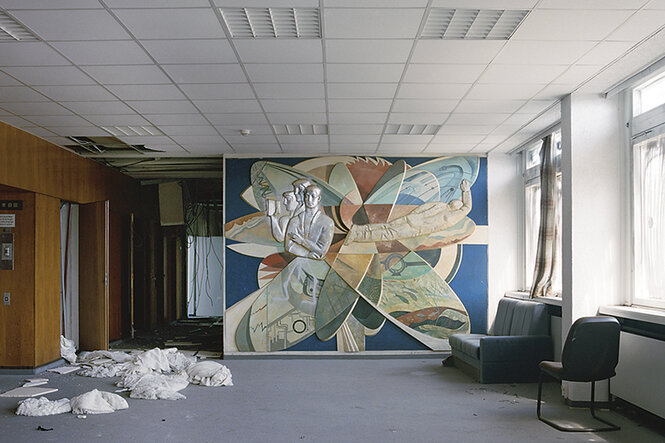 Ein Wandbild im Stil des sozialistischen Realismus in einem verlassenen Büroraum