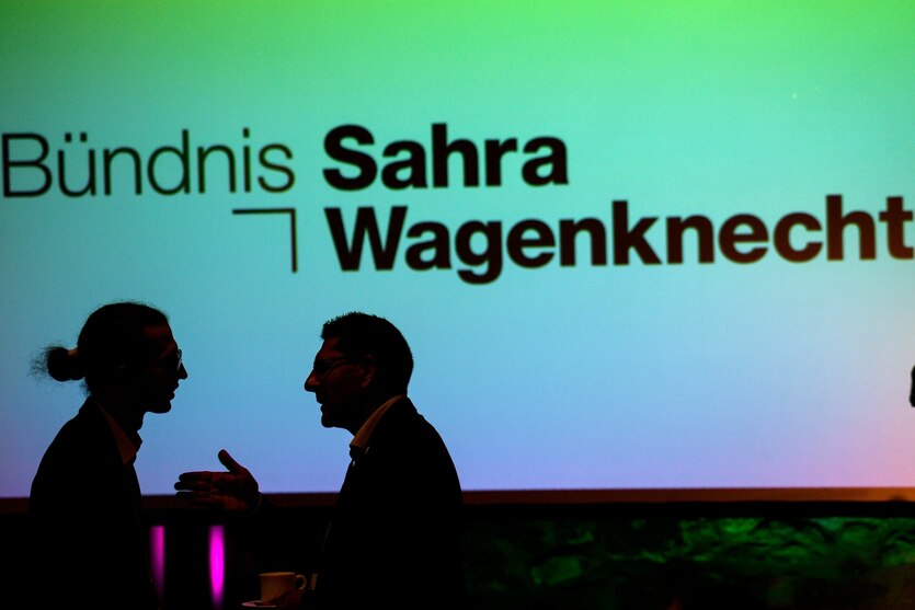 John Lucas Dittrich (l) von der Partei Bündnis Sahra Wagenknecht (BSW) und Thomas Schulze (BSW) stehen auf dem Gründungsparteitag des BSW Sachsen-Anhalt vor einer Leinwand, auf der der Parteiname projiziert ist