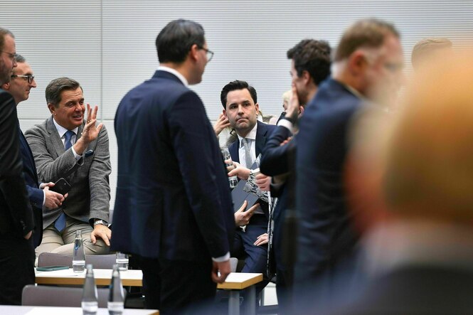 Männer in Anzügen stehen zusammen und diskutieren