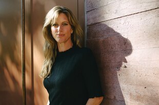 Zu sehen ist Maja Göpel, die an einer Wand lehnt und in die Kamera blickt.