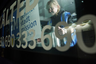 Gina Weber steht im Kältebus mit einem warmen Getränk