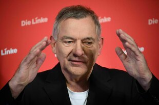 Ein Mann hält beide Hände in die Höhe.