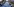 Viele Menschen auf einer Straße, die ein mehrere Meter langes Transparent tragen, auf dem Schwarz-Weiß-Fotos von Menschen sind - eine Gedenkveranstaltung für Opfer der argentinischen Militärdiktatur
