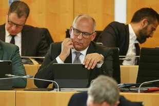 Roman Poseck blickt auf seinen Laptop