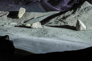 Große Steine liegen zwischen Sand