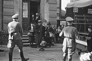 Jüdische Bürger*innen verlassen ein Haus in Lörrach und gehen zu einem LKW, von Soldaten umgeben