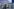 Eine Kamerafrau filmt eine Wand mit Fotos von Menschen ab, über denen steht "G20 - Soko Schwarzer Block Öffentlichkeitsfahndung 2"