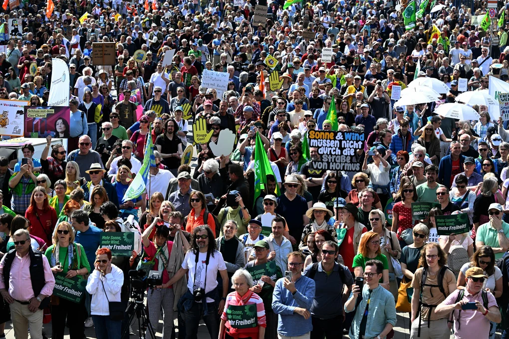 Teilnehmer und Teilnehmerinnen der Demonstration unter dem Motto ?Erneuerbare Energien verteidigen? stehen am Münchener Siegestor.